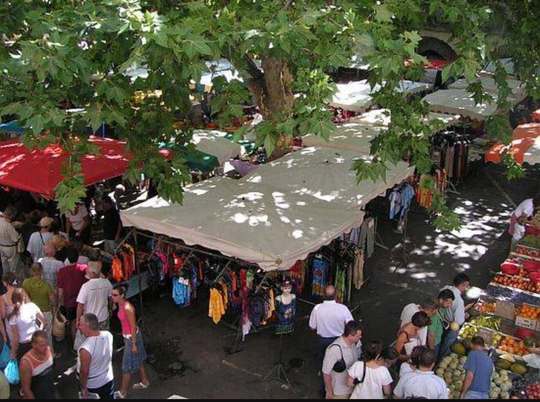 Market stalls under the plane trees in Sommières