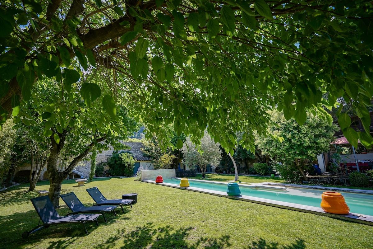 The walled garden and lawn running alongside the lap pool