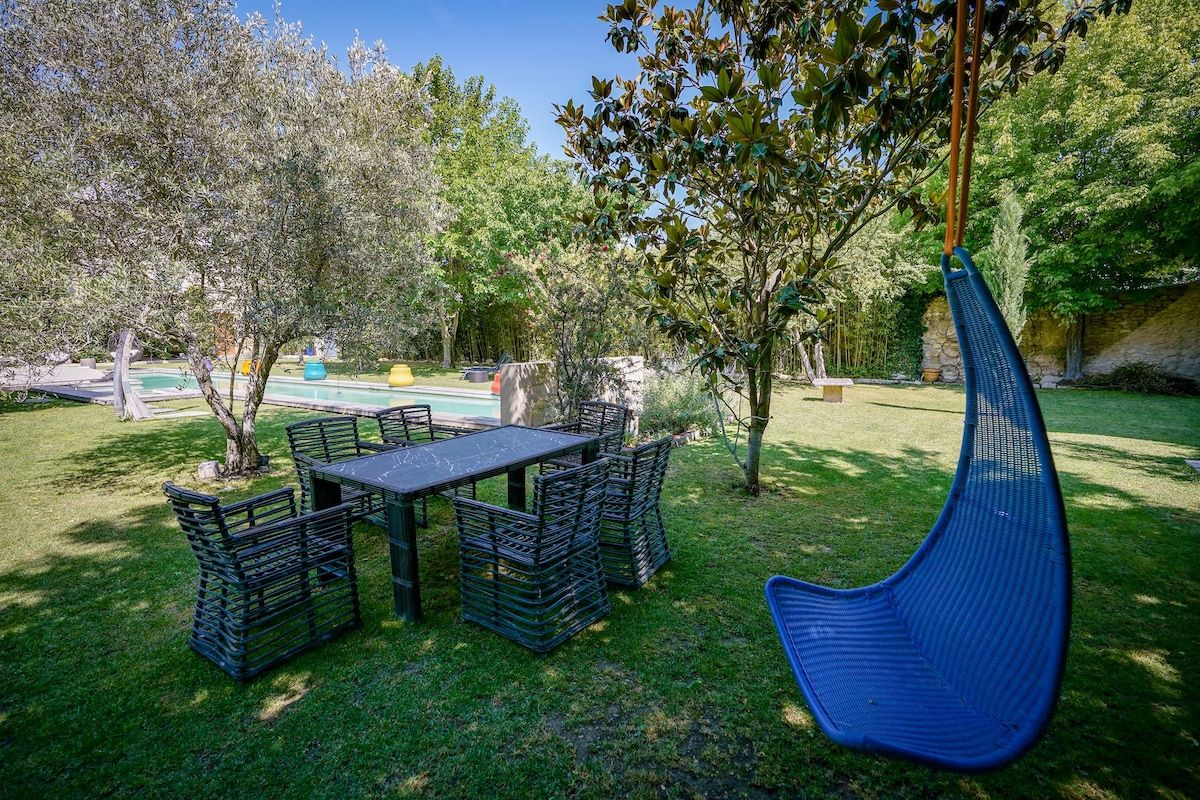 A hanging chair in the shade of the garden trees