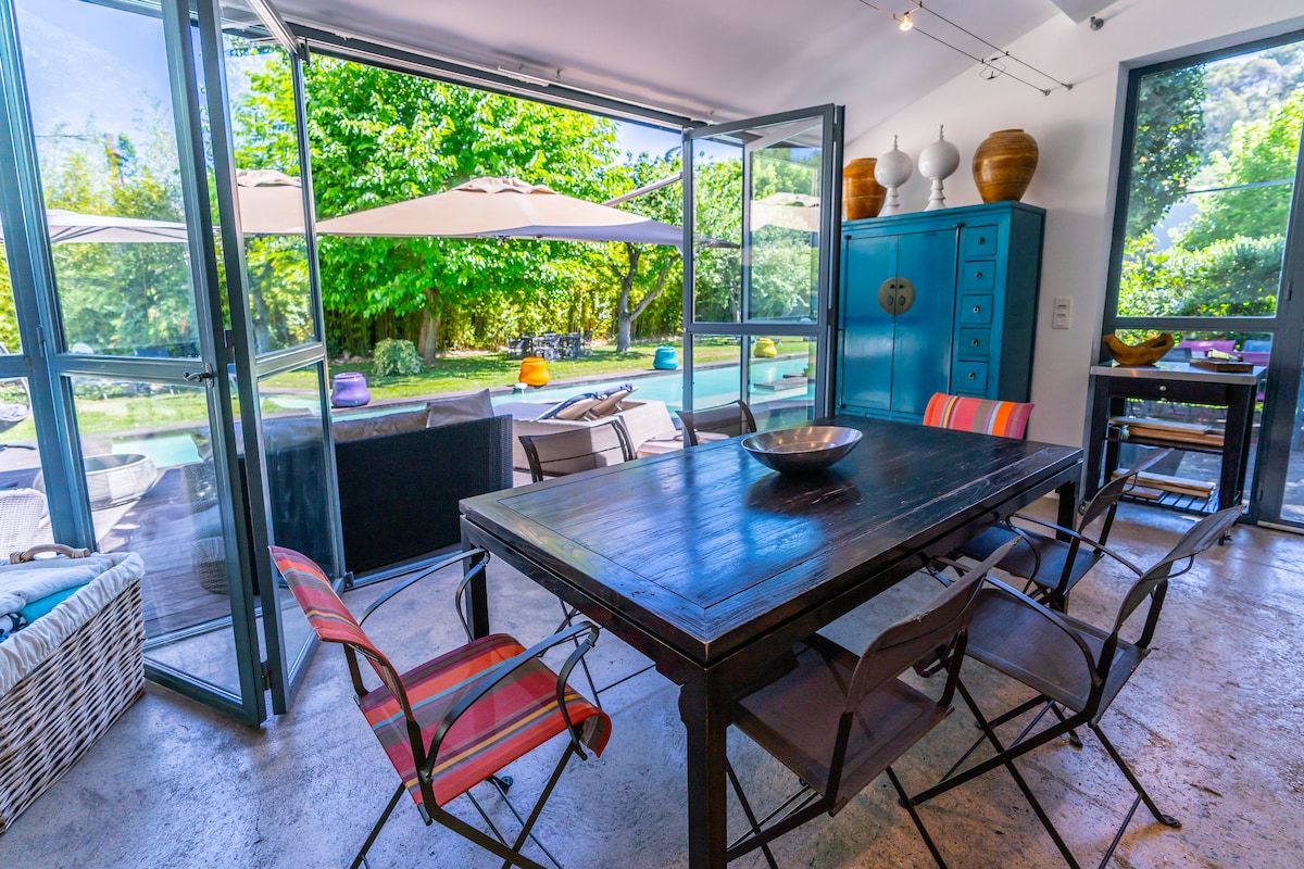 The kitchen's own dining table, glazed on two sides and open to the garden