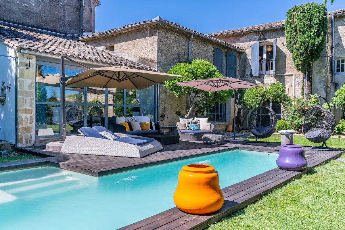 The pool terrace, with sun loungers and parasols along the water